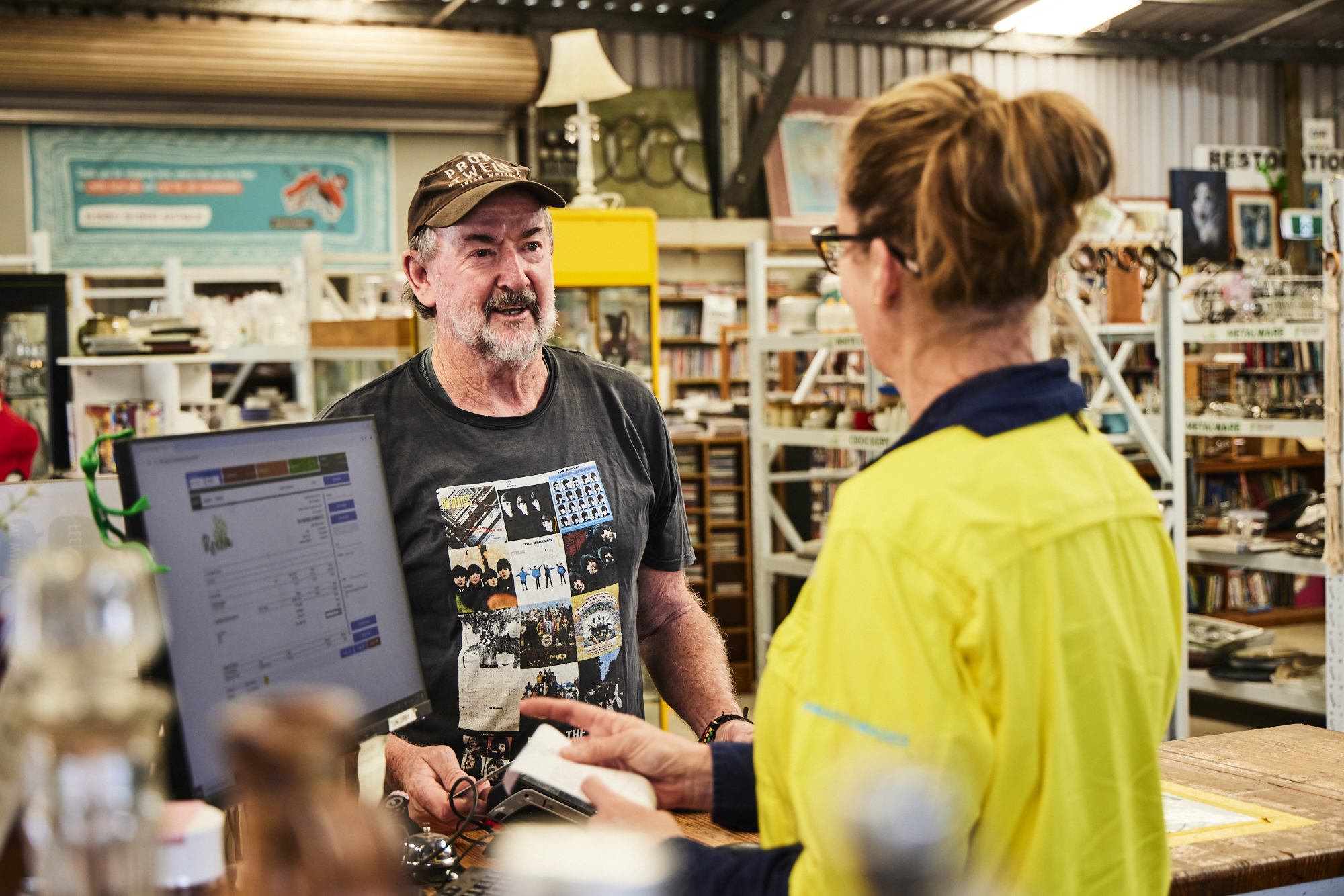 Man Using Measuring Tape in Factory Setting Man Using Measuring Tape in Factory Setting