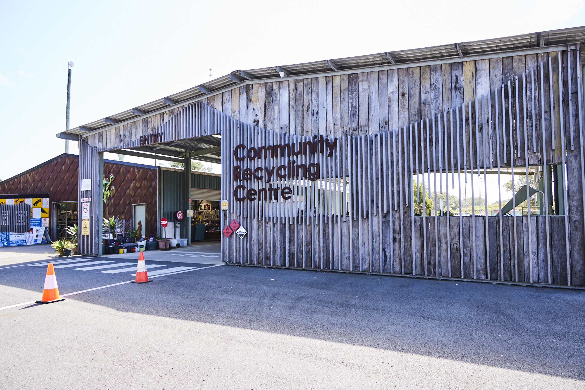 Man Using Measuring Tape in Factory Setting Man Using Measuring Tape in Factory Setting