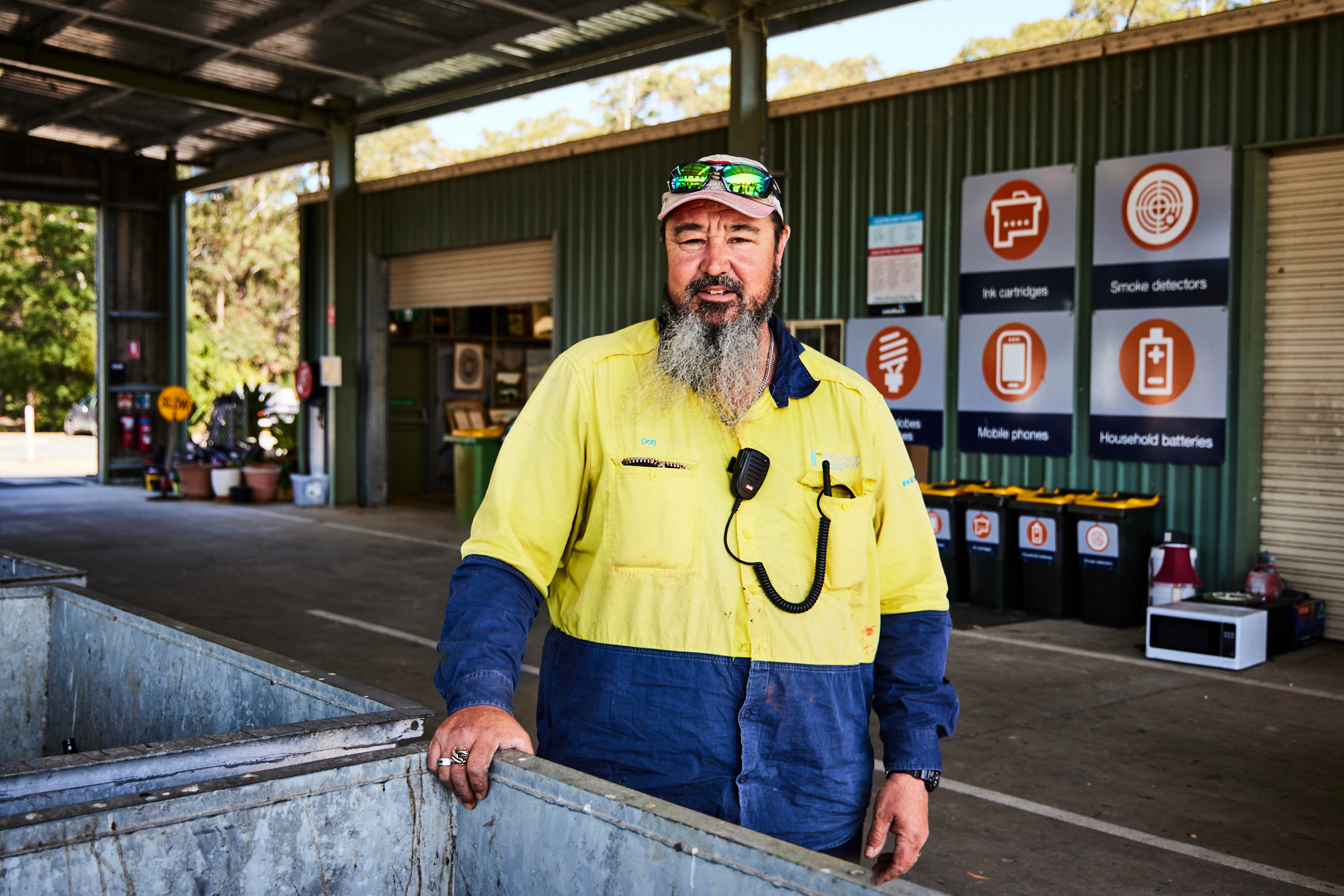 Man Using Measuring Tape in Factory Setting Man Using Measuring Tape in Factory Setting