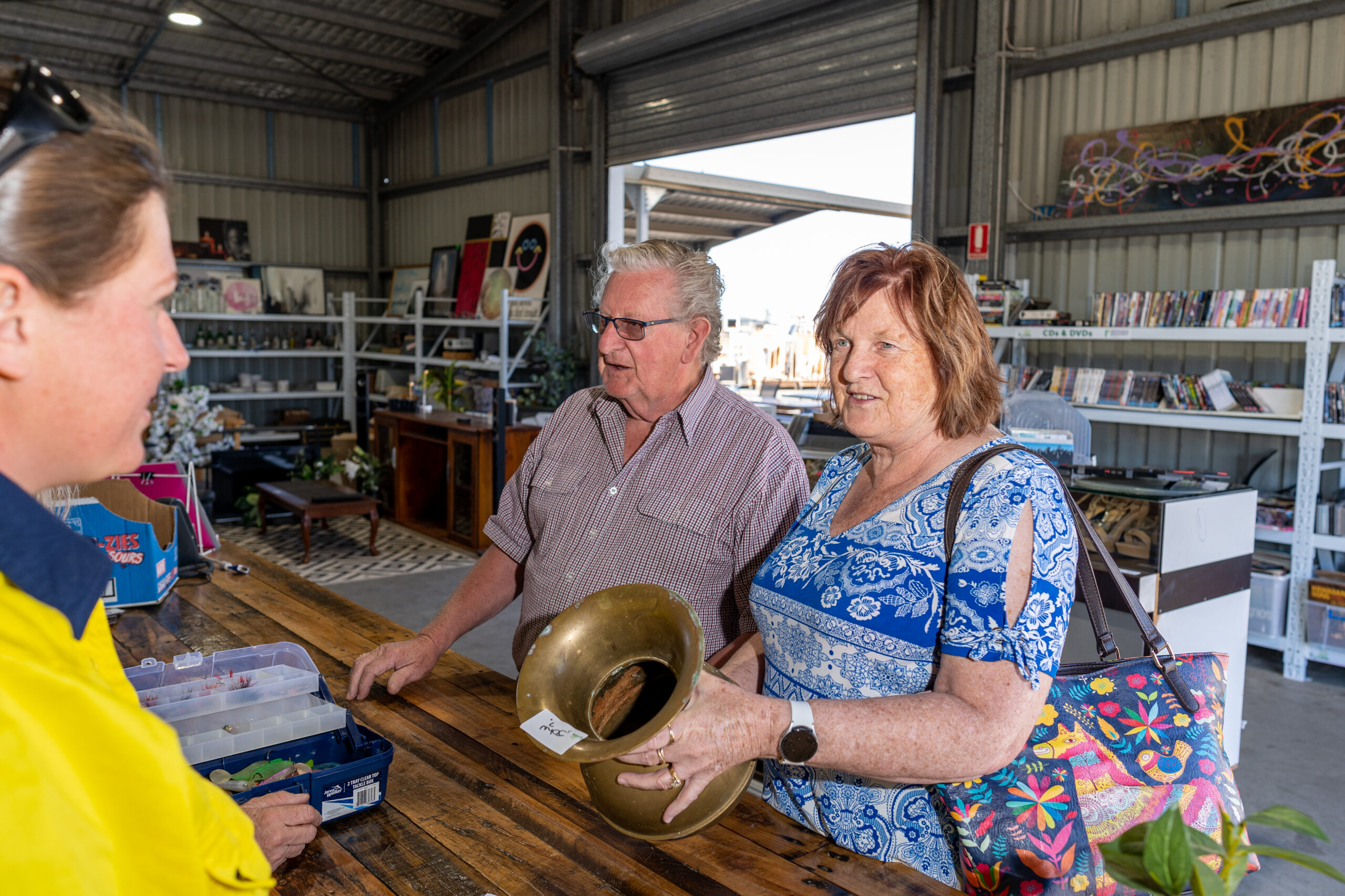 Man Using Measuring Tape in Factory Setting Man Using Measuring Tape in Factory Setting