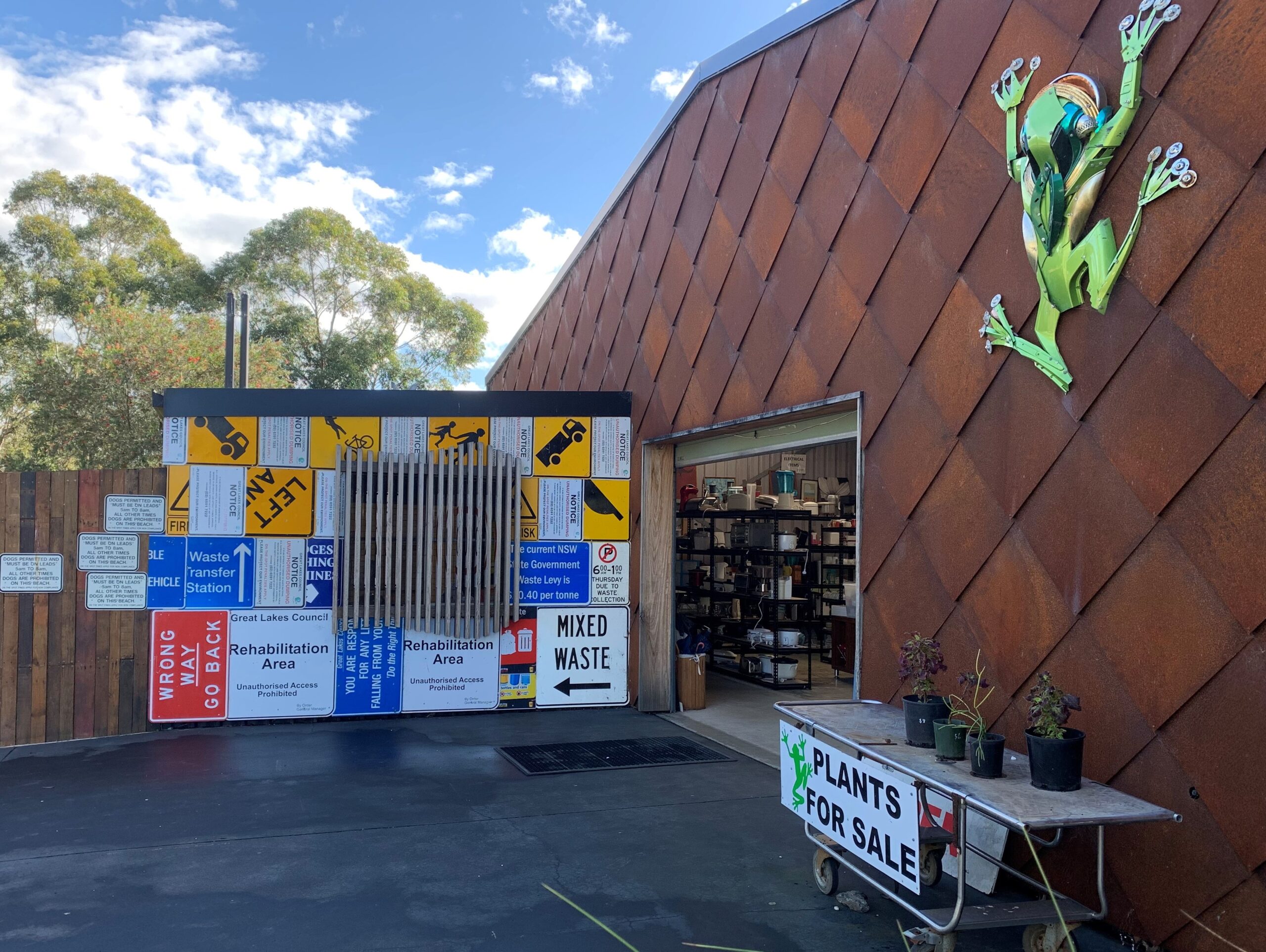 Man Using Measuring Tape in Factory Setting Man Using Measuring Tape in Factory Setting
