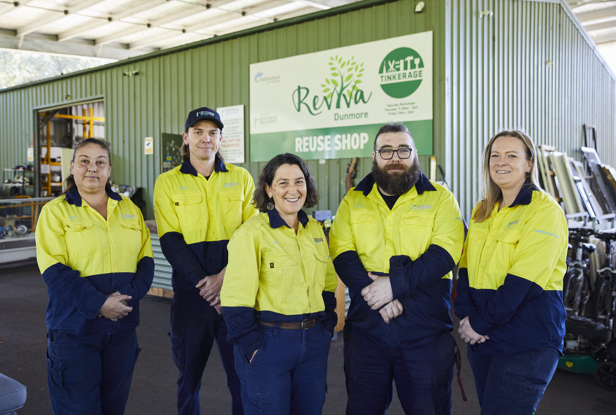 Man Using Measuring Tape in Factory Setting Man Using Measuring Tape in Factory Setting