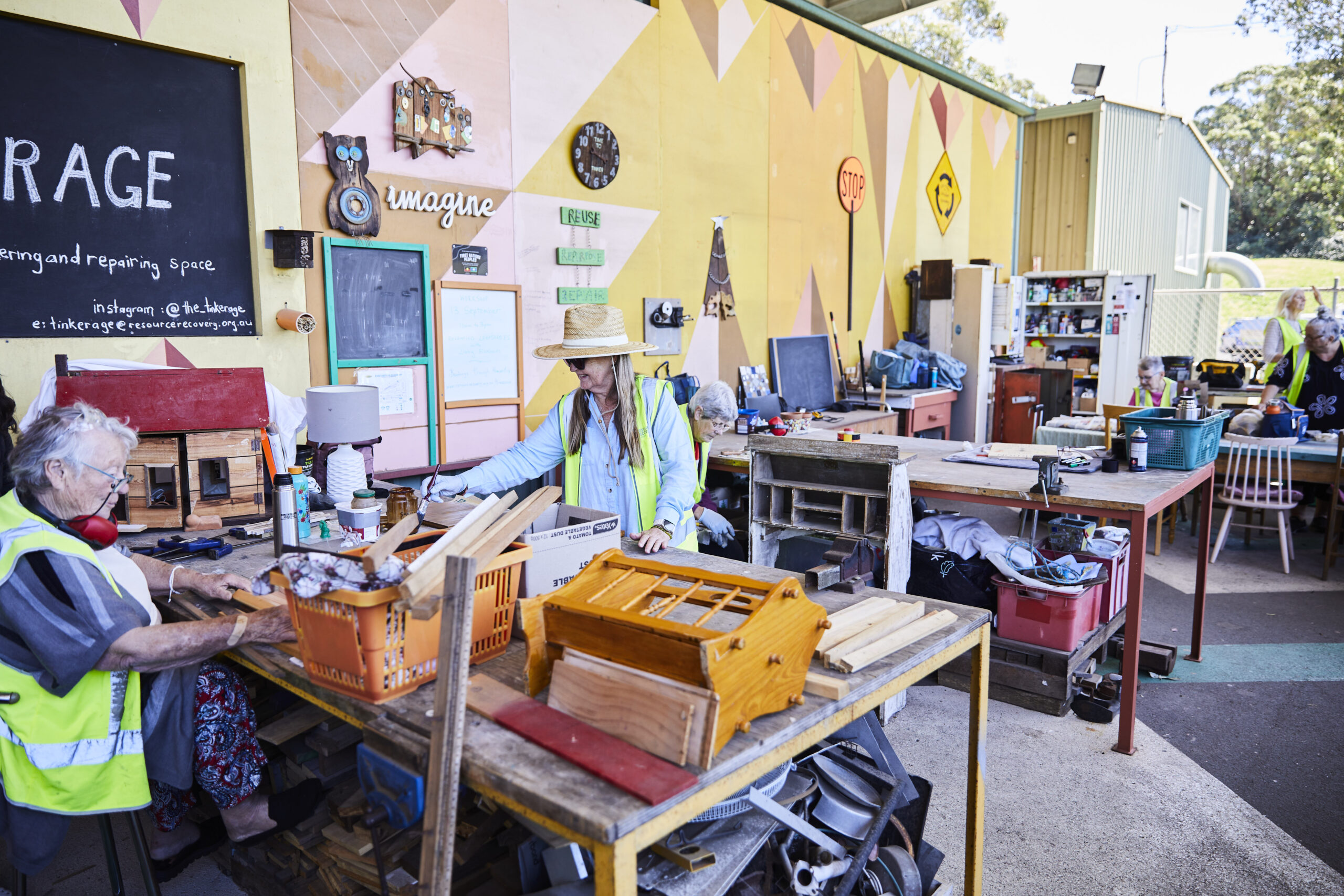 Man Using Measuring Tape in Factory Setting Man Using Measuring Tape in Factory Setting