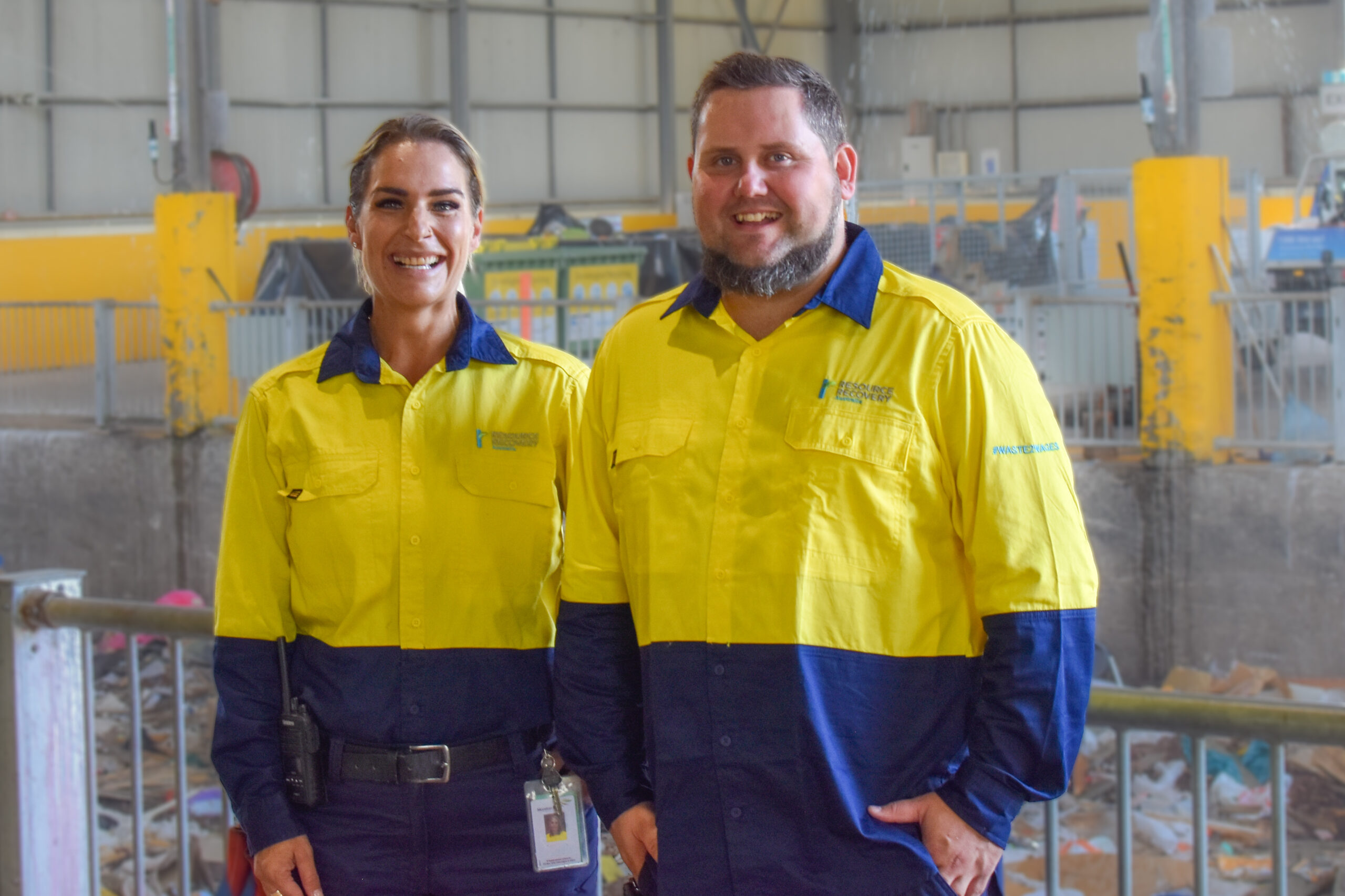 Man Using Measuring Tape in Factory Setting Man Using Measuring Tape in Factory Setting